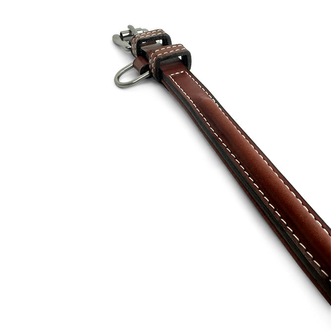 The Bentley Raised Collar by Hanks Belts is shown against a plain white background, featuring brown English bridle leather, white stitching, and a metal clasp.