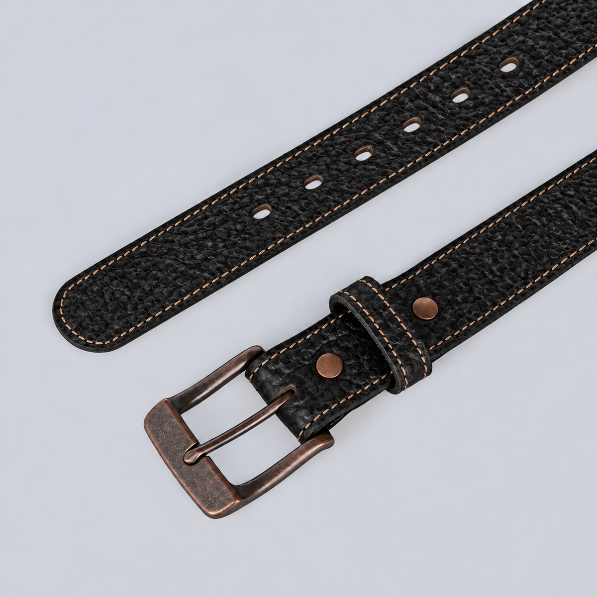 The Yellowstone - 1.25″ black leather belt with contrast stitching and a copper-toned metal buckle.
