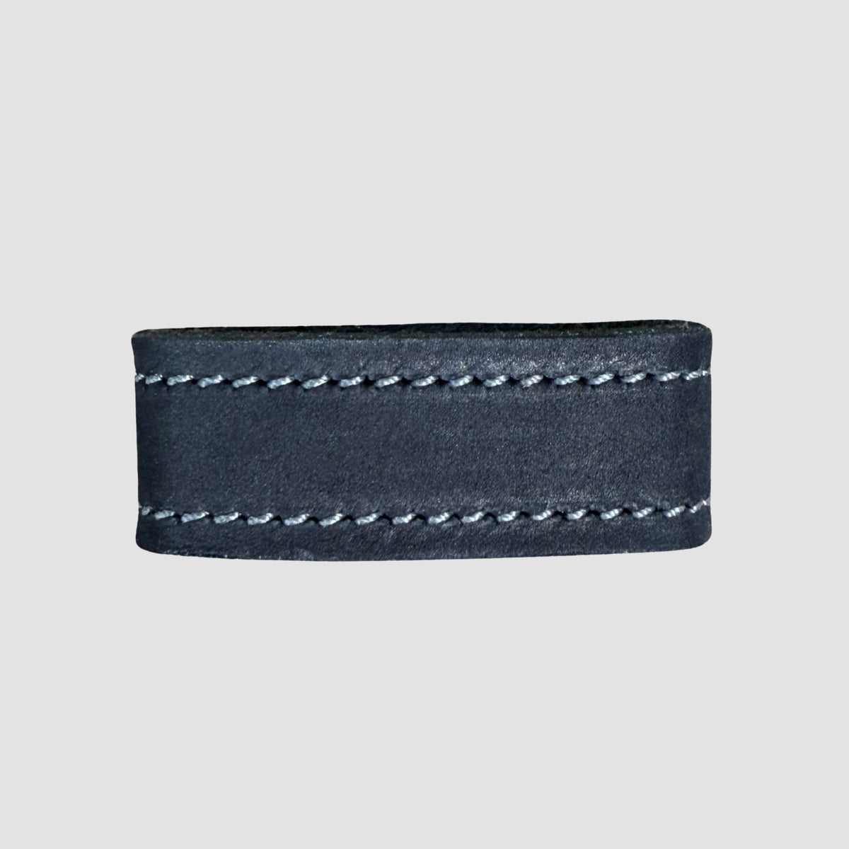 A close-up of the Hanks Belts 1.5" Suede #16 Keeper shows its dark suede leather band with visible stitching, a belt keeper detail, and a plain light gray background.