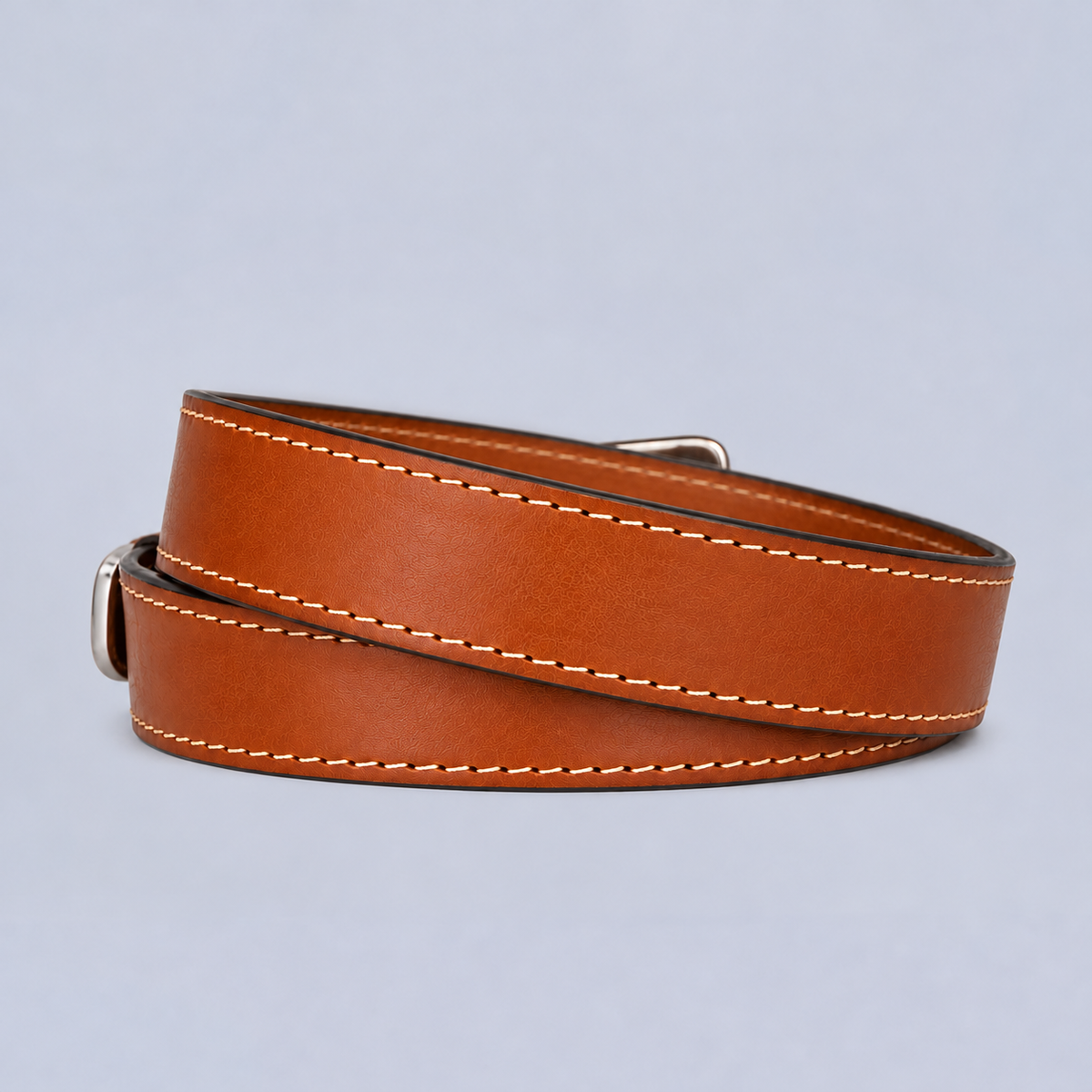 Coiled tan leather The Xtreme - 1.5″ heavy duty belt with white stitching and a silver buckle.