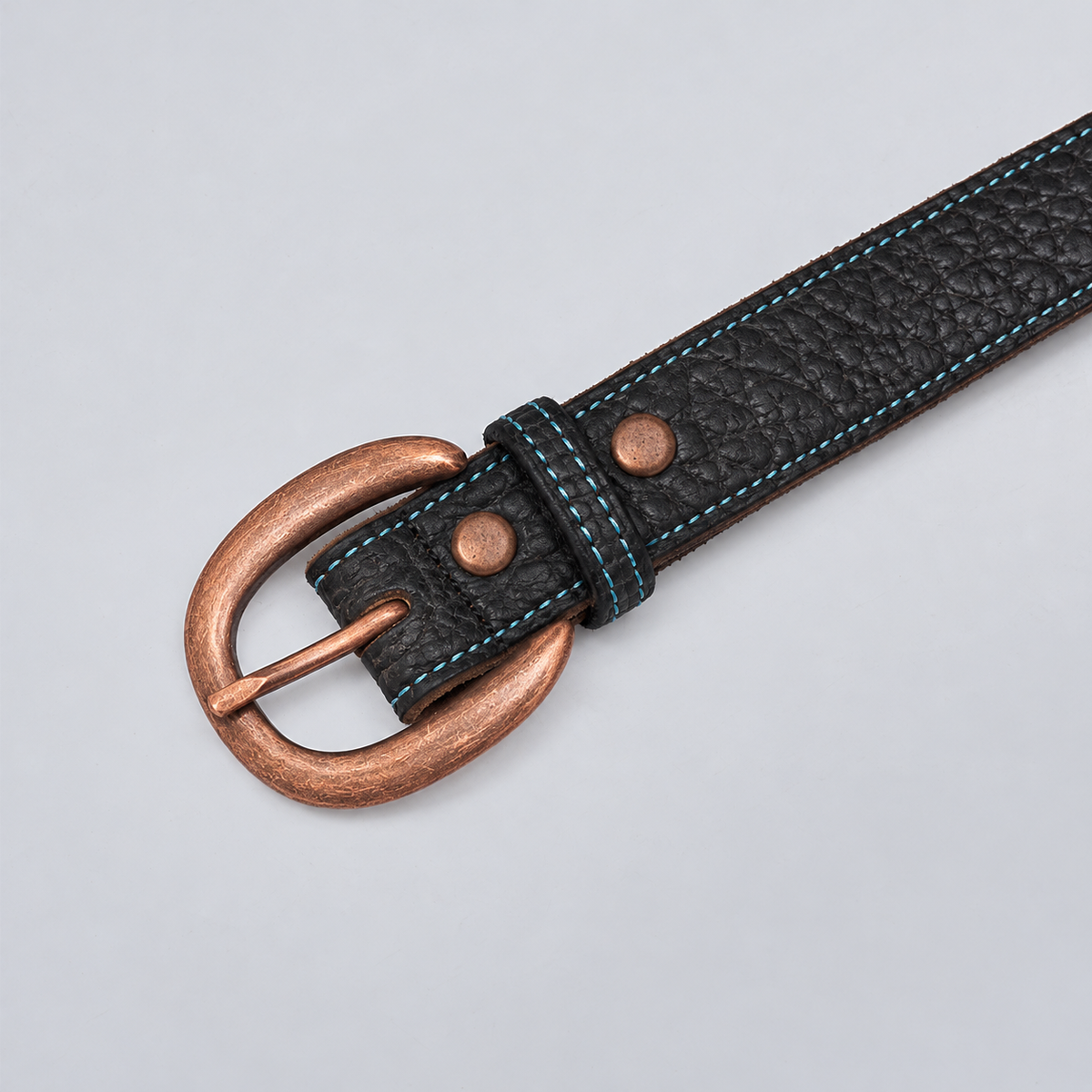 The Yellowstone for Women 1″ with Stitched Center: black textured bison leather belt with blue stitching and copper buckle.