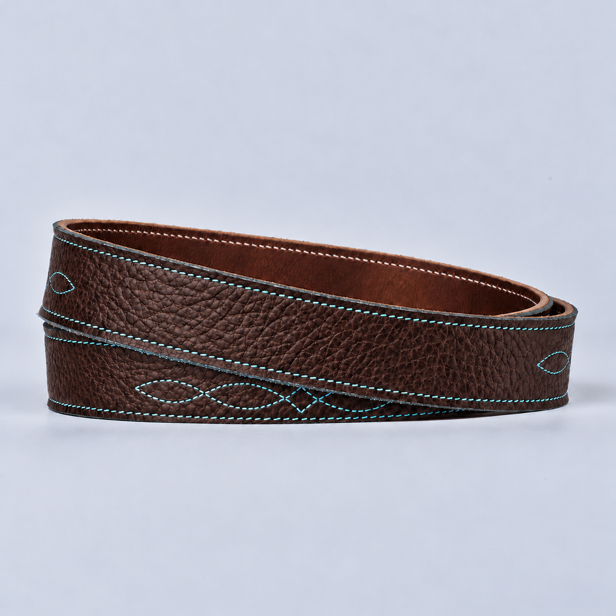 The Yellowstone for Women 1″ with Stitched Center: a coiled durable bison leather belt with decorative teal stitching.