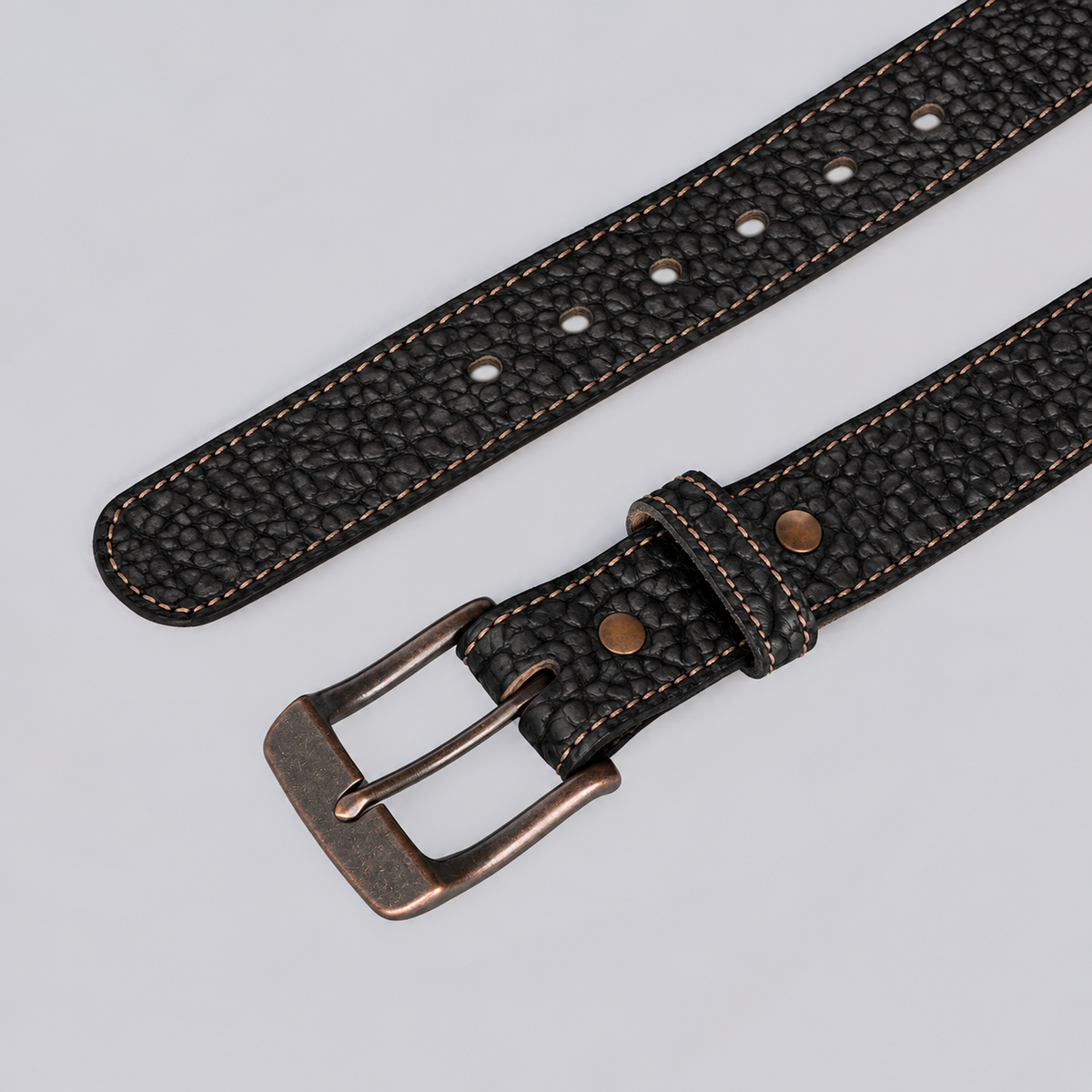 The Yellowstone durable bison leather belt in black texture with a copper-tone buckle.